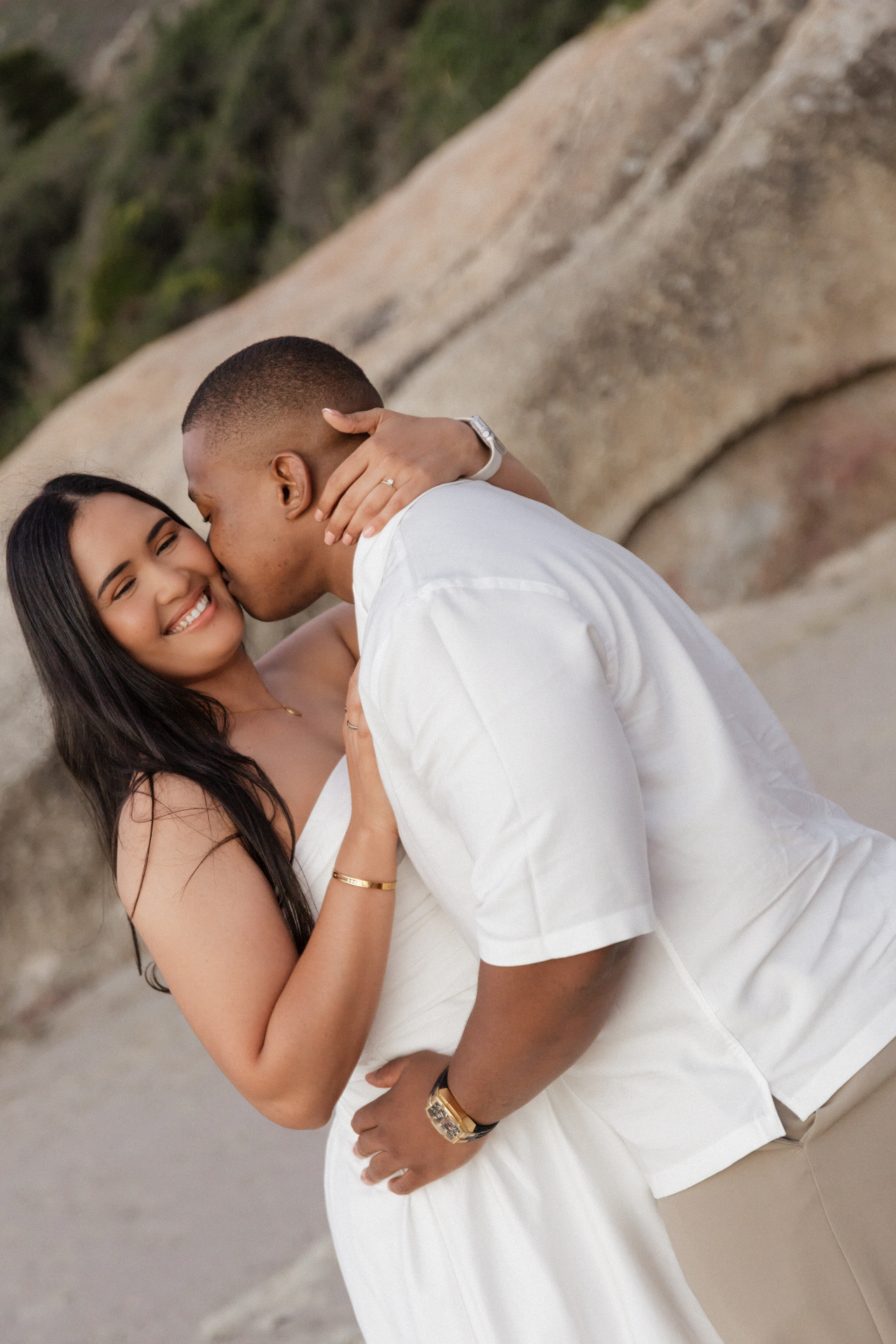 A tender kiss against the rocks